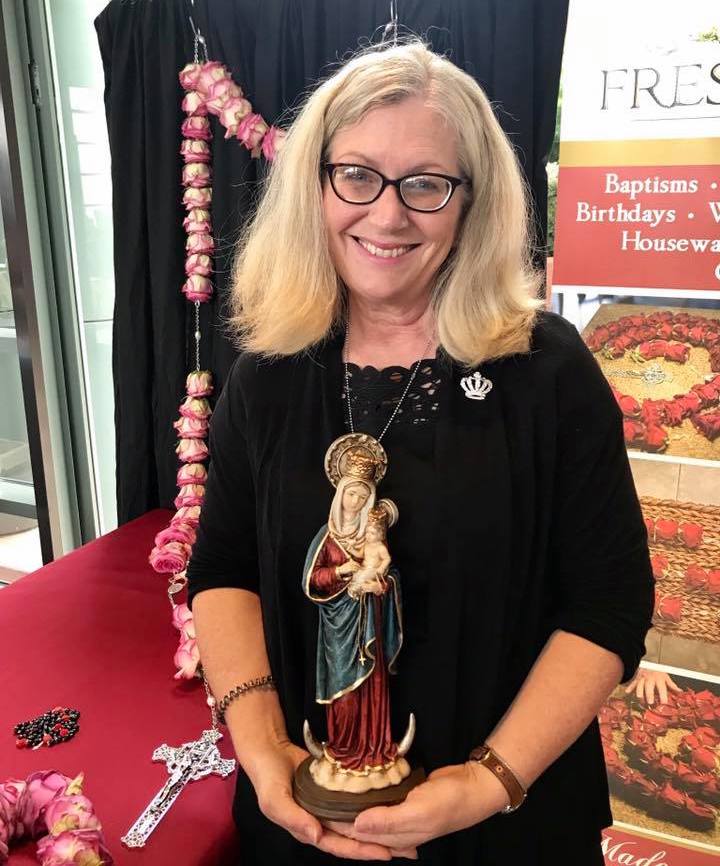 Julia Dreves Miller by a Fresh Rosary display